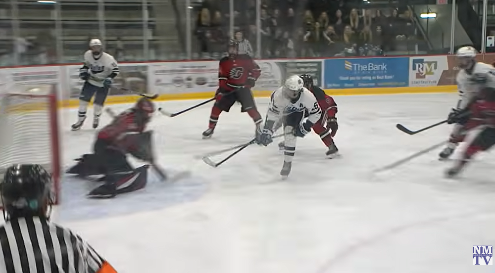 A Blaine High School Boys Hockey player takes a shot on goal against Centennial.